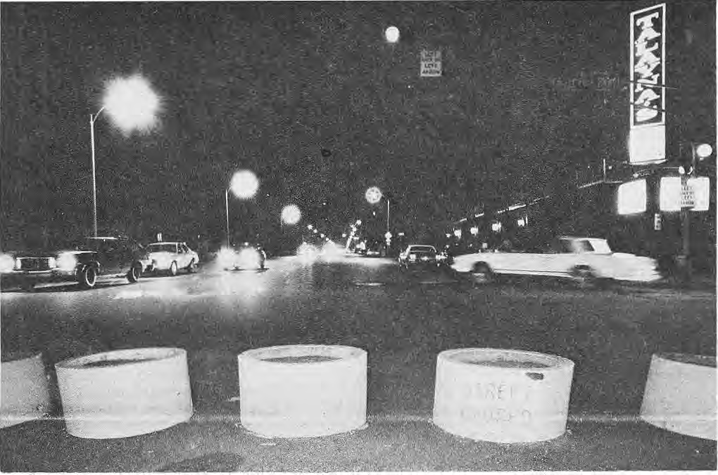 Night view of Skinker with concrete barriers in the foreground.