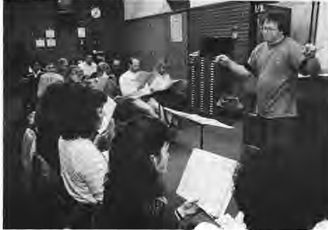 Camerata Singers at rehearsal, including Lisa Horner,Mary Schmit,Terry Vanicelli and Father Paul Rothschild. Photographer not credited.