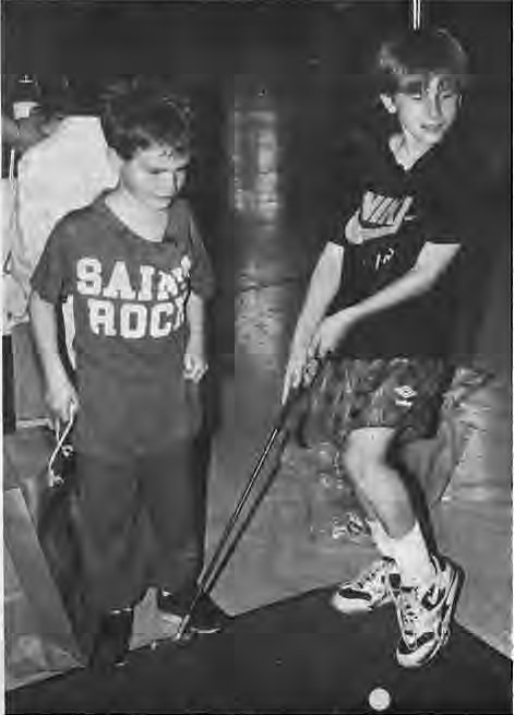 Playing Hole in One are kindergartener Peter Fanson and third grader Mike Korman. Photographer not credited.