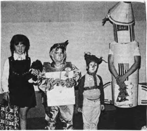 Children display their costumes at the 1977 neighborhood Halloween party.