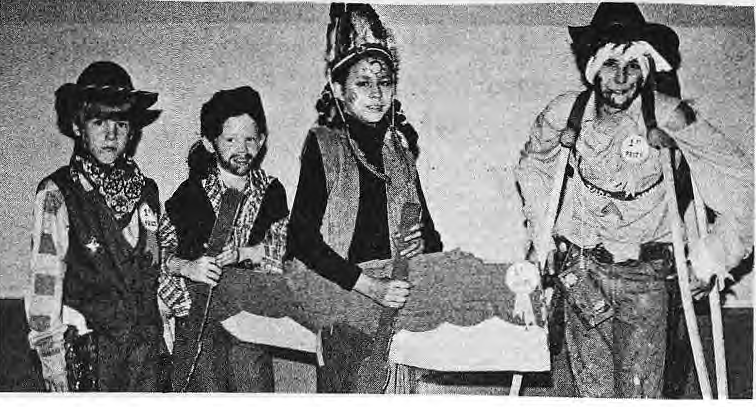 Children display their costumes at the 1977 neighborhood Halloween party.