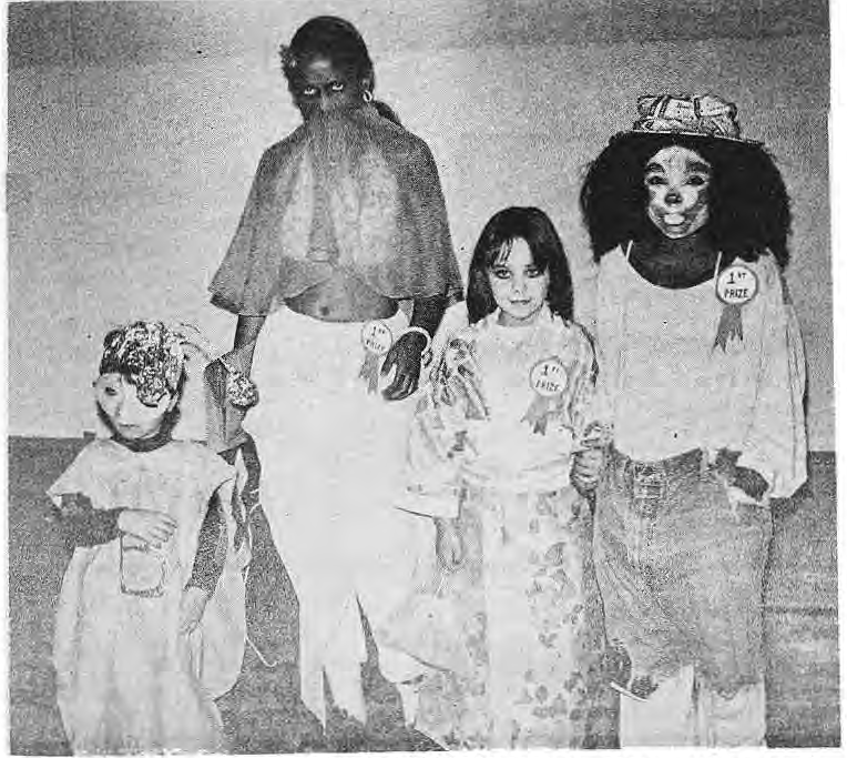 Children display their costumes at the 1977 neighborhood Halloween party.