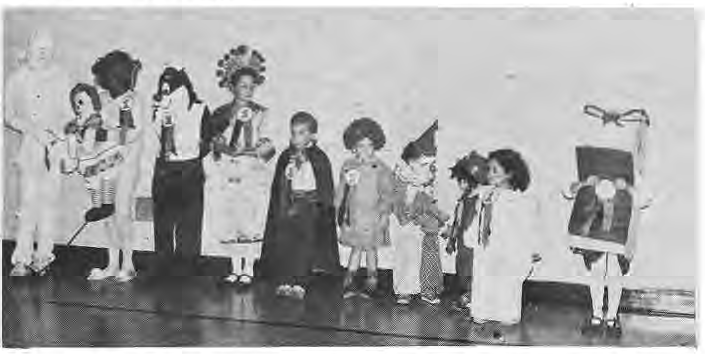 Children wearing prizewinning costumes at the neighborhood Halloween party.