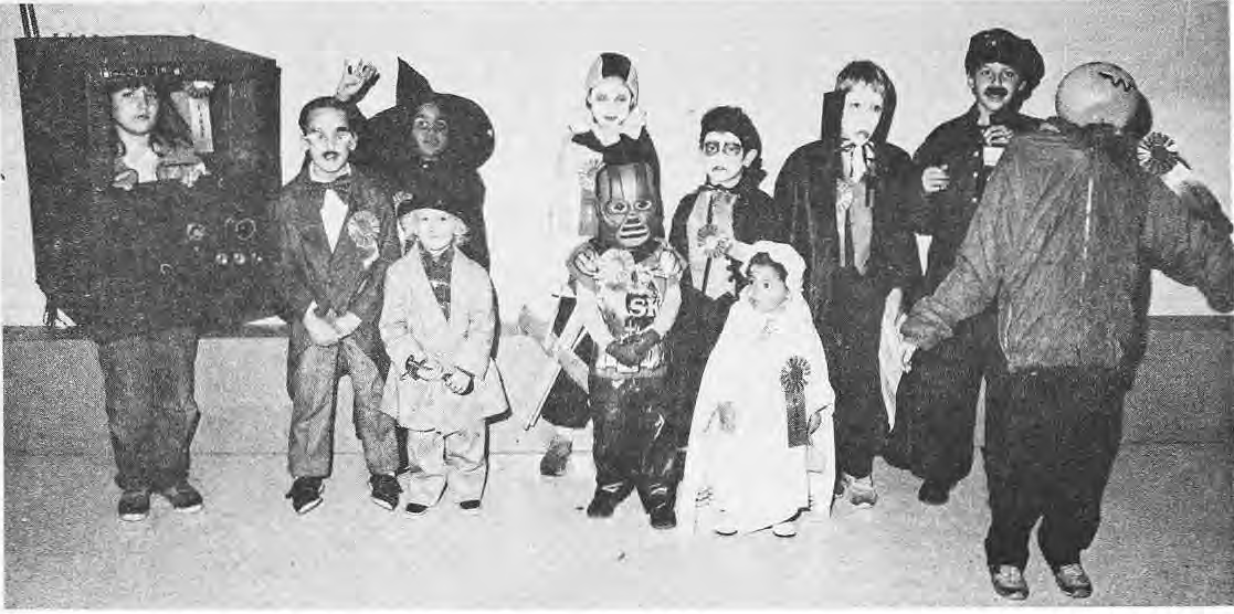Children in costumes at the Halloween party.