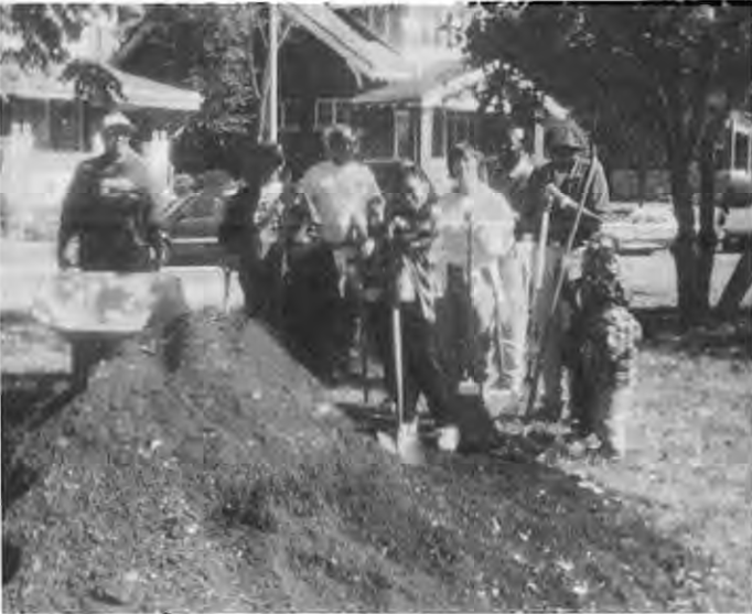Ready for gardening,beautification volunteers gather in the brilliant sun for a group picture. Photographer not credited.