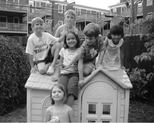 Children atop Baybeck playhouse at New Neighbors Party.