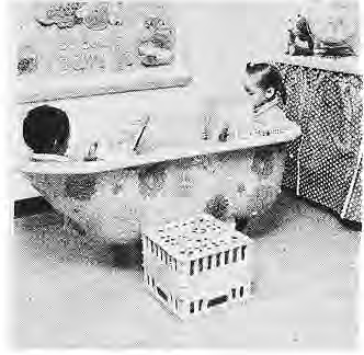 A child reads in a decorated classroom reading bathtub.