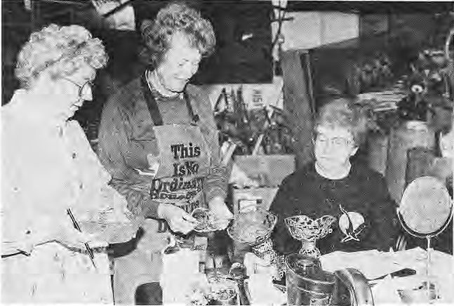 Volunteers inspecting household objects for the Historical Society flea market.
