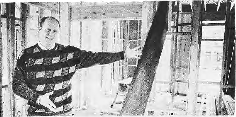 Sandy Rothschild standing in his unfinished kitchen.