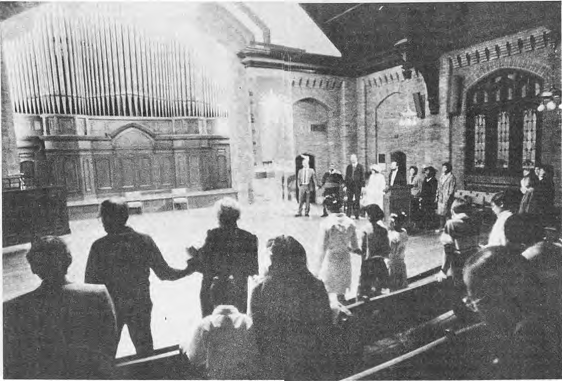 Participants holding hands across the church at the King commemoration.