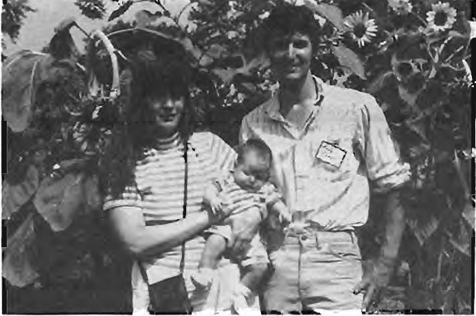 Andy and Linda Cross and their youngest,Sarah Jane,about to be overwhelmed by the sunflowers at McPherson Garden. Photographer not credited.