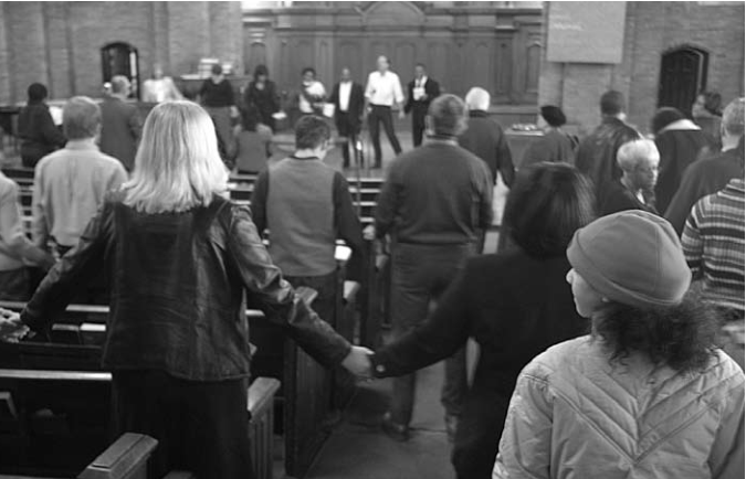 Community members join hands at Martin Luther King celebration.