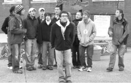 Men’s singing group performs at Wintermarkt. Photographer not credited.
