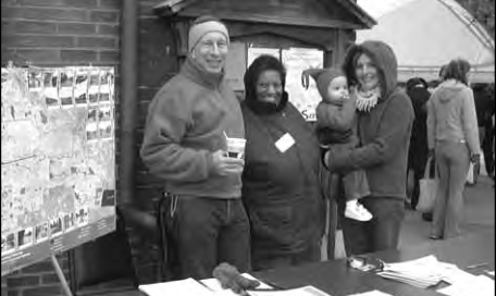 Alice Stanley, middle, with past president Dan Schesch and Wintermarkt visitors.