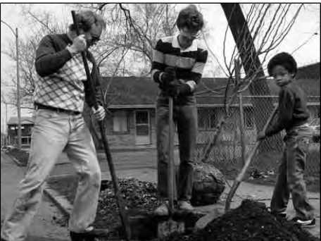 Sam Green with neighbors planting trees on Des Peres.