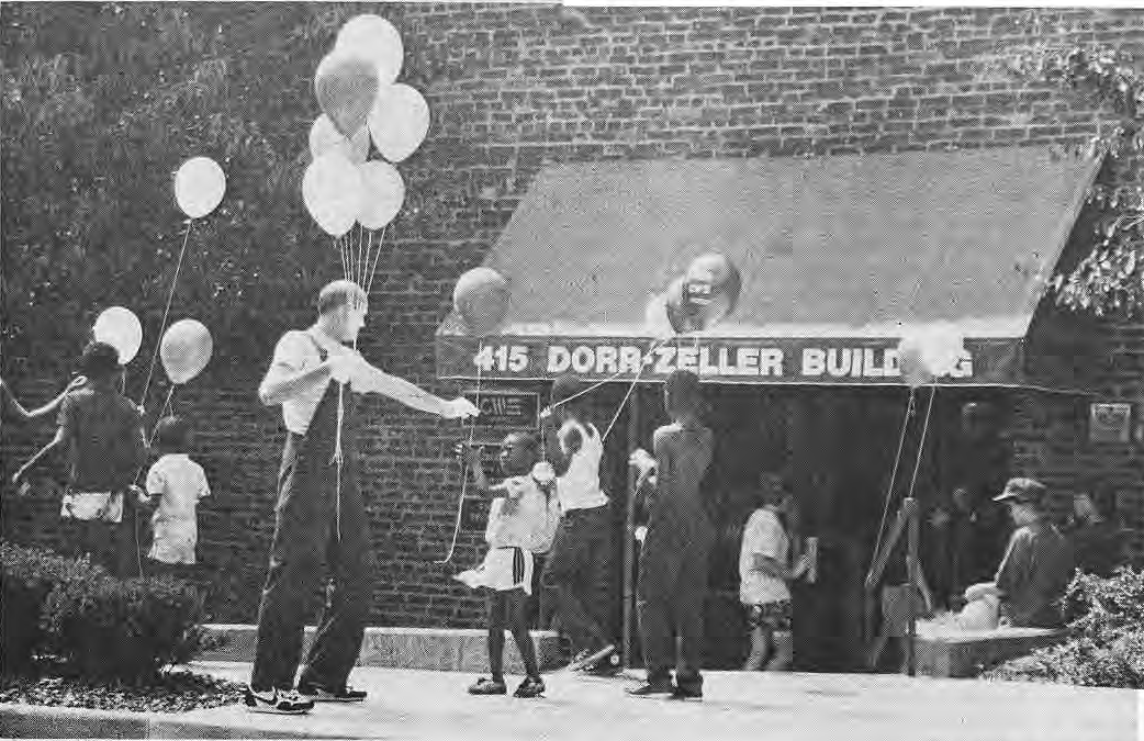 Birthday celebration outside Central West End Savings and Loan at 415 DeBaliviere.