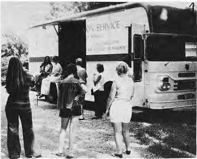Original photograph of people beside the home-maintenance service van.