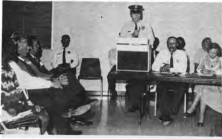 Police representatives and residents at the Team Policing program; Sergeant Robert Alexander speaks.