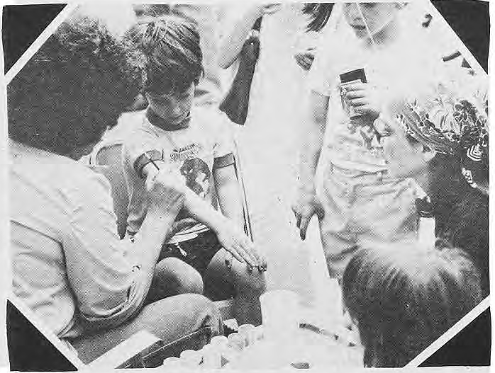 A child having a design painted on an arm.