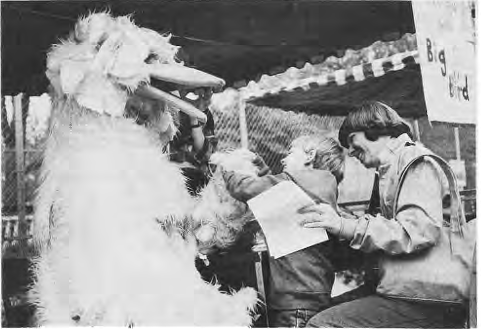 Children at the New City School Fair interacting with Big Bird.