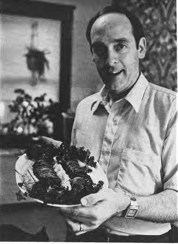 Brad Weir holding a platter of pork tenderloin.
