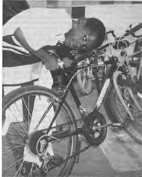Youth Cycles participant, Antione Parker, polishes his new wheels. Photographer not credited.