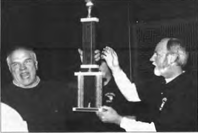 A jubilant Coach Jerry Imming(left)accepts the CYC Championship trophy. Photo by Kenneth Vanderbeek.