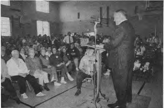 SDCC President Gary Hayes addresses rally before march on April 19 at St. Roch’s Gymnasium. Photo by Ed Stout.