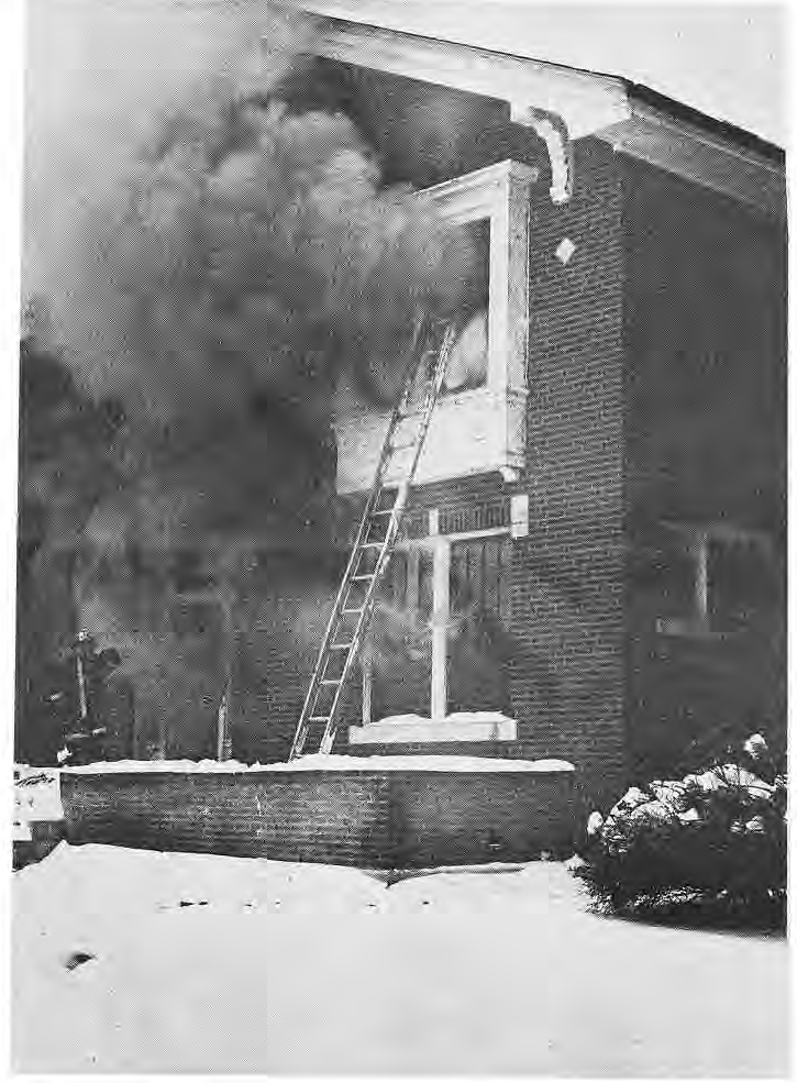 Original photograph of firefighters at a smoking house in winter.