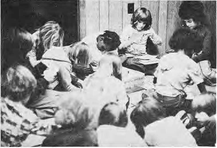 Original photograph of children gathered around a classroom table.