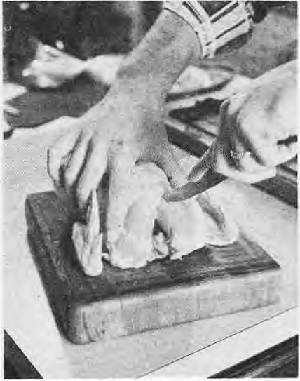 Close view of locating the wishbone while preparing a chicken.
