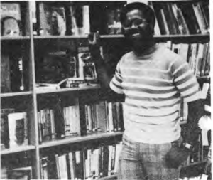Original photograph accompanying the Charles Brown departure report, showing him standing in the library.