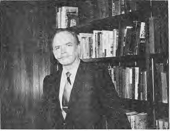Rev. Robert Gordon, identified by the printed photograph caption, seated beside bookshelves.