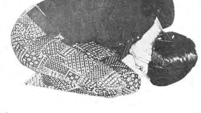 A participant demonstrating a folded yoga pose at St. Roch’s; photograph by Sue Johnson.