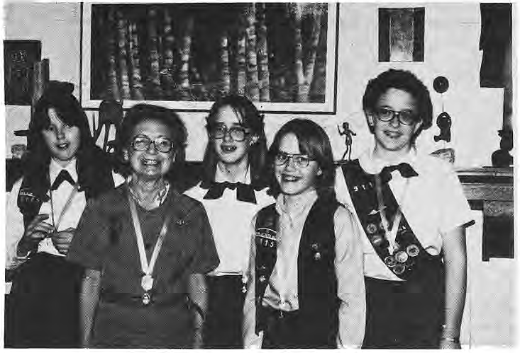 Original photograph of Rita Magyar and four Girl Scouts at the awards ceremony; caption identity discrepancy retained.