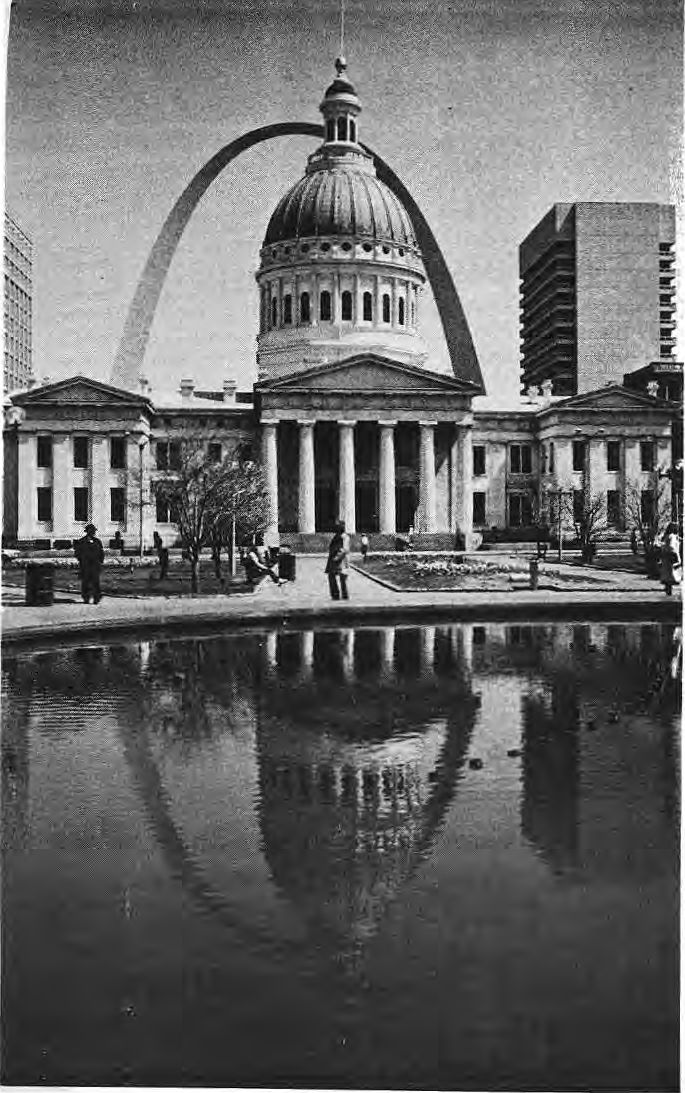 Old Courthouse and Gateway Arch reflected in the foreground pool.