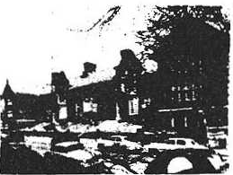 Original Hamilton school building photograph with cars parked in front.