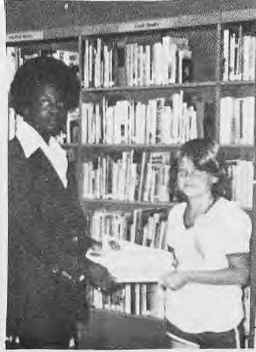 Original library photograph of a standing man and seated child; identities not inferred.