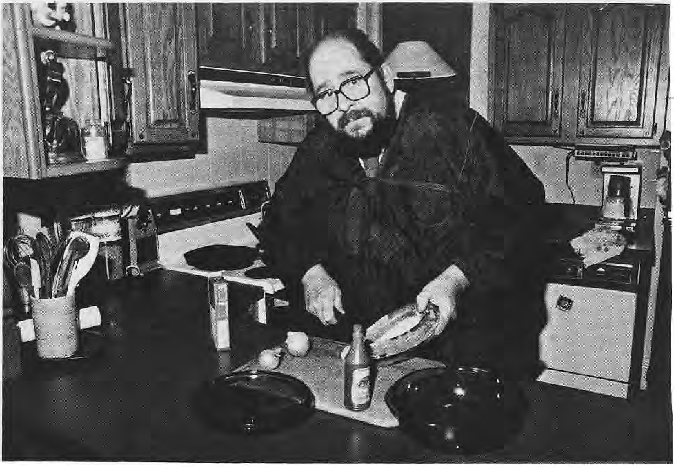 Peter Schmit preparing a recipe at his kitchen stove.