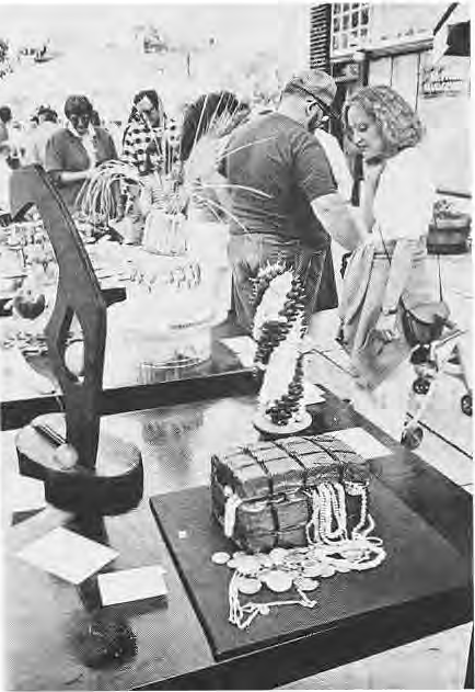 Edible art was one of the features of Art Exposed; here (foreground) a chocolate cake treasure chest with candy coins and a mixed fruit “tree.”