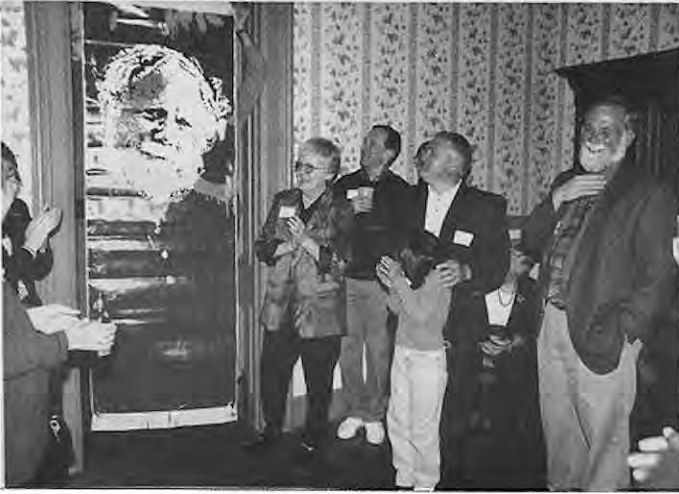 An appreciative crowd was present for the unveiling of the banner honoring Dan McGuire at the Times’New Neighbors party,October18,at Cabanne House in Forest Park. Photographer not credited.