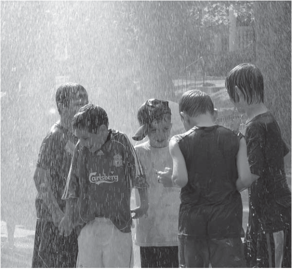 Children enjoy water play at the May 31 Mc Pherson Centennial party.