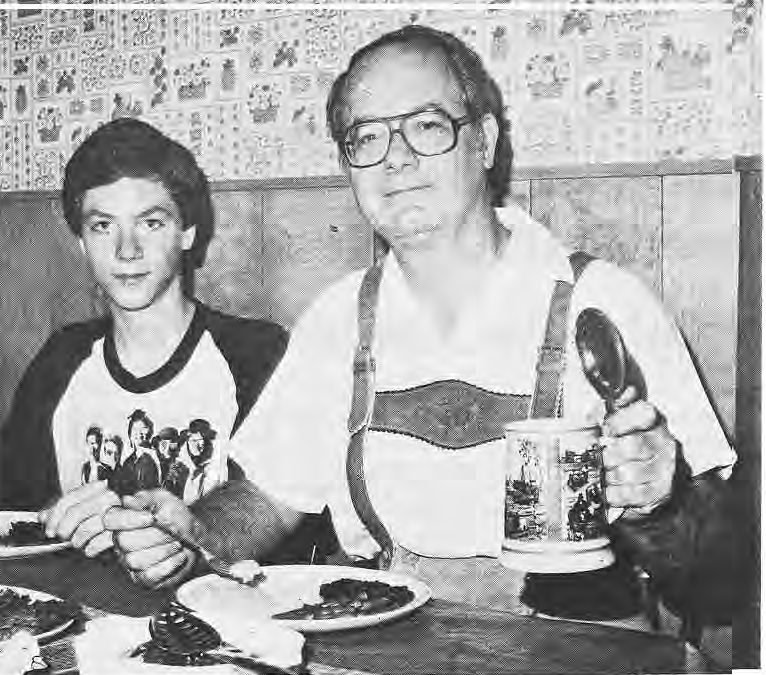 Art Santen preparing potato pancakes with a young helper.