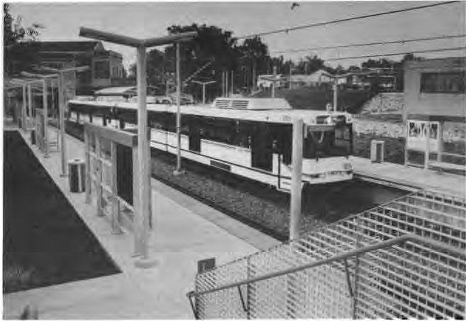 Looking south at the Delmar Metrolink station. At upper left is the back of the old Delmar railroad station. Photographer not credited.