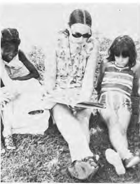Miss Sherry Eckrich reading with children at the Des Peres library