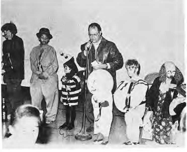 Costumed children accepting prizes at the Rosedale-Skinker Halloween party