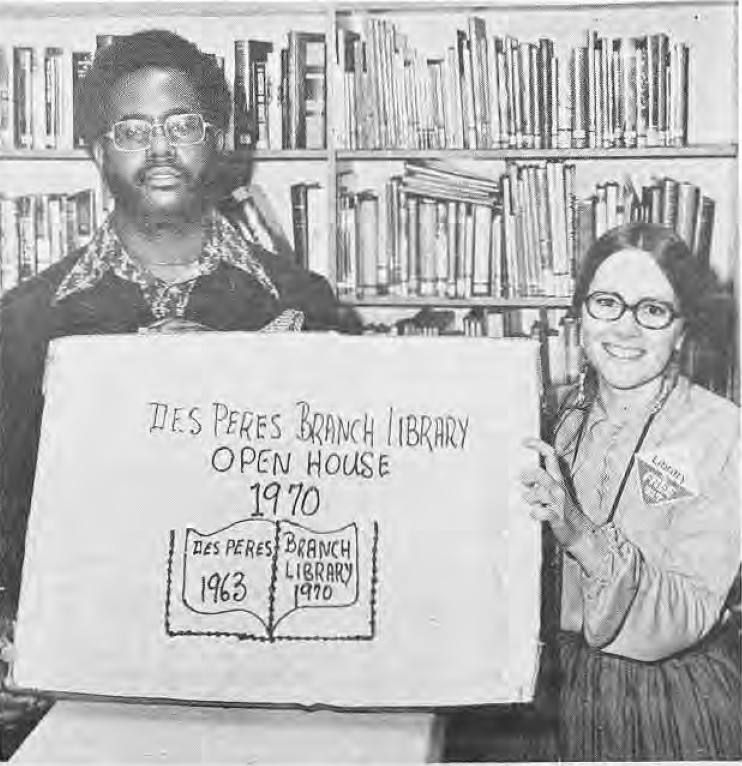 Charles Brown and Sherry Eckrich holding a library-shaped cake
