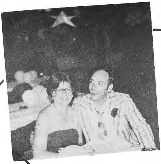 A seated couple at the neighborhood prom.