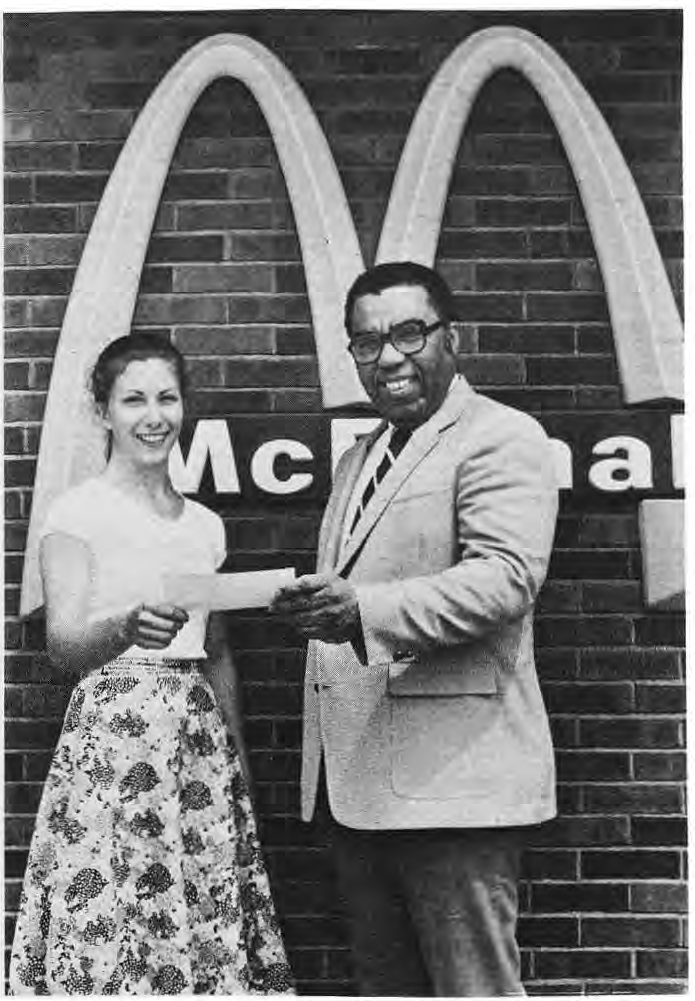 James Perry presents a donation to Ann FitzGibbons for the Young People’s Scholarship Fund.