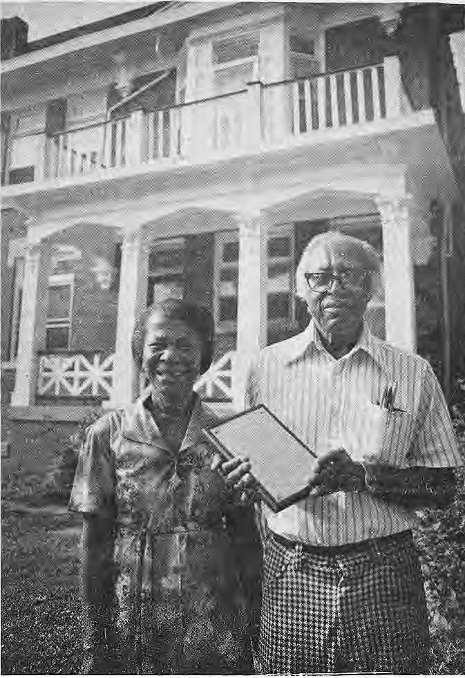 Mr. and Mrs. Joe Addison holding their neighborhood home-improvement award.